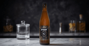Infusiion Beer bottle with a glass showcasing strong beer in India with rich foam and golden color